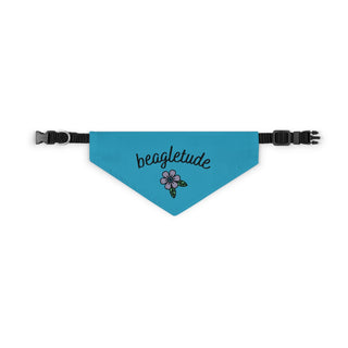 The Signature Tattoo Flower Dog Collar Bandana in Blue. The Signature Tattoo Flower design features the word "beagletude" with a tattoo style flower under it. Comes with adjustable black collar.