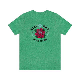 Stay Wild Unisex Premium Tee in Heather Kelly. Shown is front of Stay Wild Design features a tattoo style rose with the phrase "Stay Wild, Play Hard" around it. The back of shirt features the Stay Wild Benefit Beagle Logo Design.