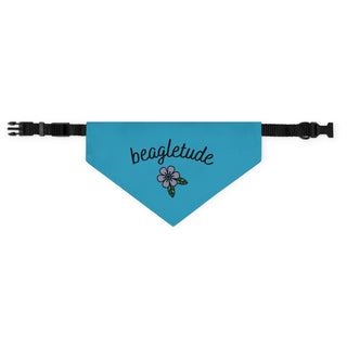 The Signature Tattoo Flower Dog Collar Bandana in Blue. The Signature Tattoo Flower design features the word "beagletude" with a tattoo style flower under it. Comes with adjustable black collar.