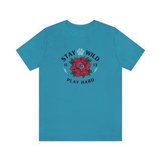 Stay Wild Unisex Premium Tee in Aqua. Shown is front of Stay Wild Design features a tattoo style rose with the phrase "Stay Wild, Play Hard" around it. The back of shirt features the Stay Wild Benefit Beagle Logo Design.