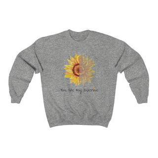 You are my Sunshine Unisex Crewneck Sweatshirt in Sport Grey. Shown is the front showcasing a sunflower which is split down the middle and half is made out of paw prints. Underneath is the phrase "You are my Sunshine" . Back of shirt features the Sunflower Benefit Beagle Logo.