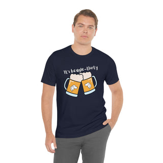 Beagle-Thirty Mugs Unisex Jersey Short Sleeve Tee in Navy. The front of shirt showcases Two Dog Adorned Mugs clinking with the saying, "It's Beagle-Thirty" above it. Back of shirt features corresponding Benefit Beagle Logo.