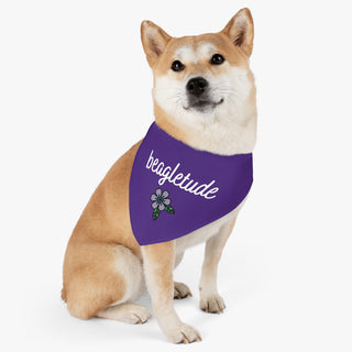 Dog wearing the Signature Tattoo Flower Dog Collar Bandana in Purple. The Signature Tattoo Flower design features the word "beagletude" with a tattoo style flower under it. Comes with adjustable black collar.